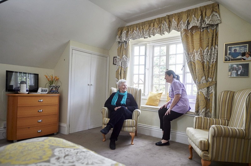 A member of the Nettlestead care team spending time with a resident