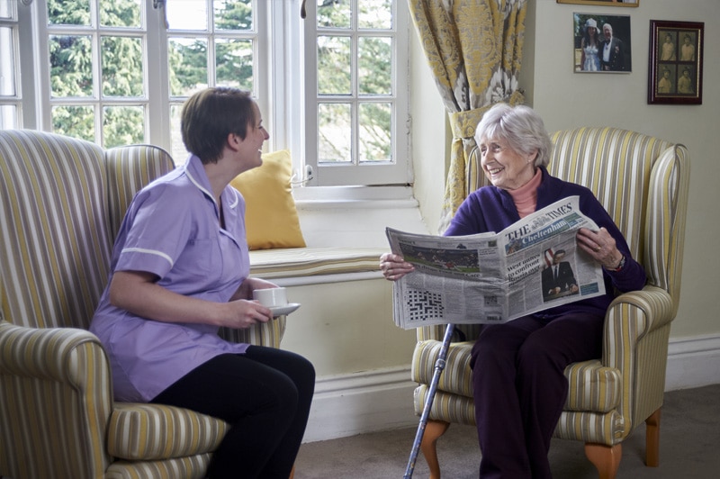 A resident sharing a warm moment with a Nettlestead team member